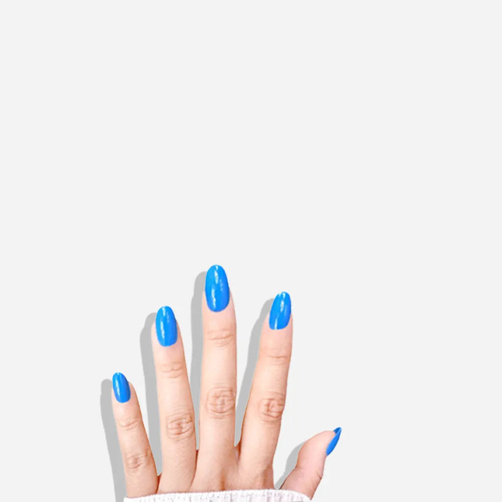 Fingers down pose showing de blinkie Skyline Pop vivid azure blue high gloss press-on nails in short oval shape against white background with white ribbed knit sleeve